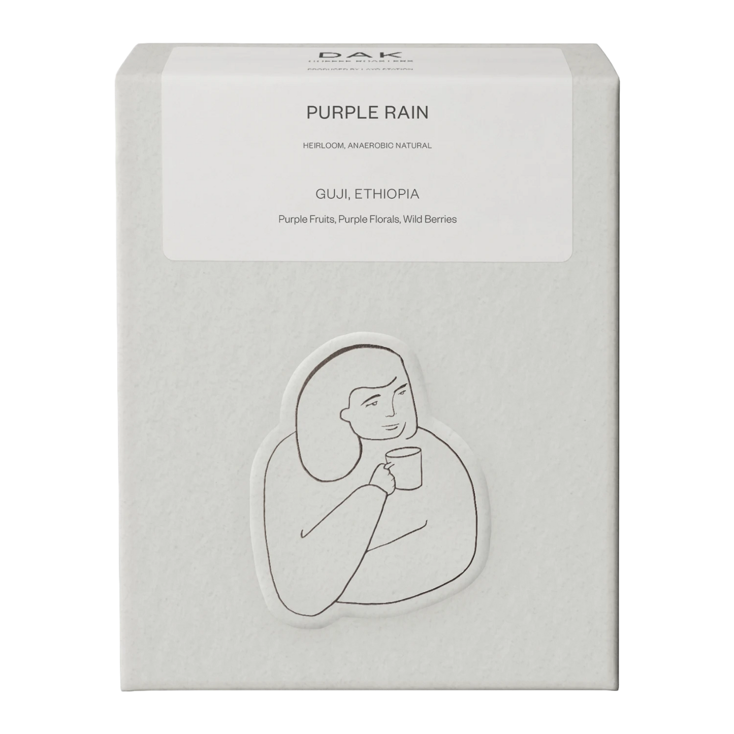 White box of DAK Coffee Roasters Purple Rain Filter Whole Beans with black on white drawing of a person