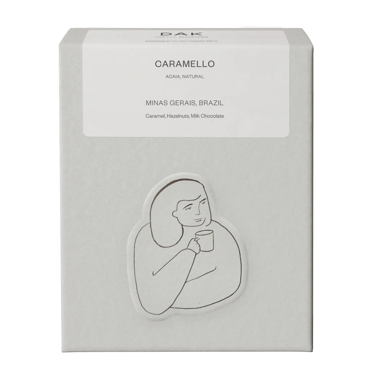White box of DAK Coffee Roasters Caramello Espresso Whole Beans with black on white drawing of a person