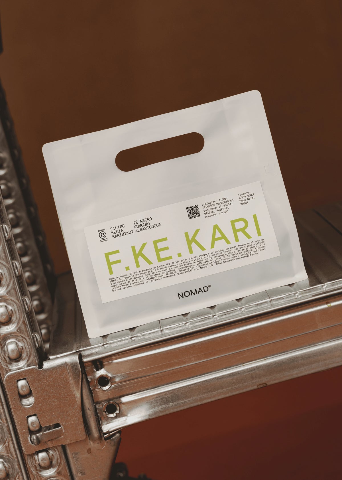 A white paper shopping bag with a handle and a printed label reading F.KE.KARI.