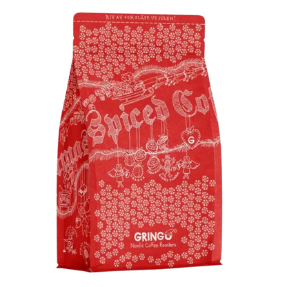 A red bag of Chrismas Spiced Coffee by Gringo Nordics with white festive illustrations and text, shown on a plain white background.