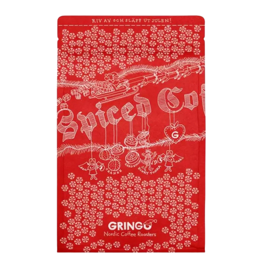 A red Christmas-themed coffee bag featuring white illustrations of a Santa train, ornaments, and snowflakes, with the brand name 'Gringo Nordic' printed at the bottom.