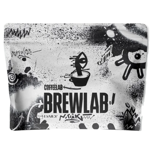 En återförslutningsbar påse med COFFEELAB Brewlab Daily-kaffe, med en svartvit graffitiliknande grafisk design med klotter och fet stil.