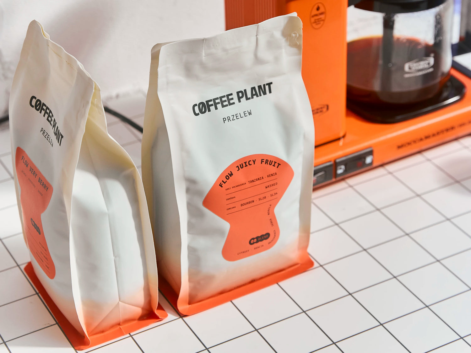Freshly roasted coffee beans pouring out of a professional industrial coffee roaster.