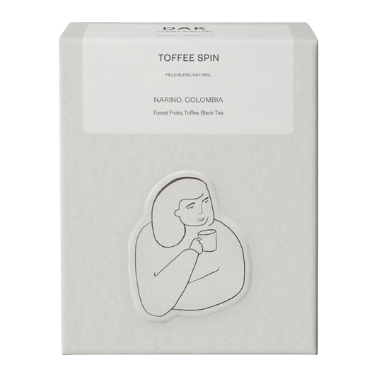 White box of DAK Coffee Roasters Toffee Spin Espresso Whole Beans with black on white drawing of a person