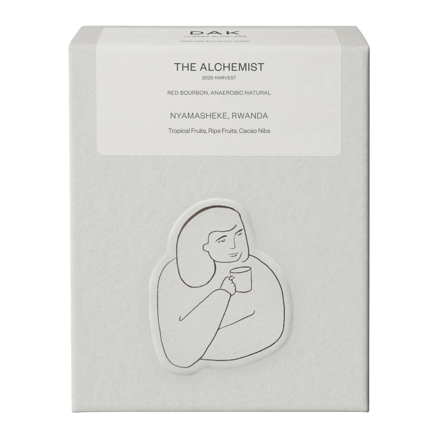 White box of DAK Coffee Roasters Rwanda The Alchemist Filter Whole Beans with black on white drawing of a person