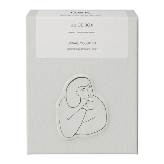 White box of DAK Coffee Roasters Juicy Box Filter Whole Beans with black on white drawing of a person