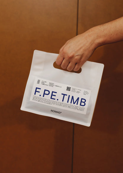 Hand holding Nomad Coffee F.PE.TIMB Peru coffee bag