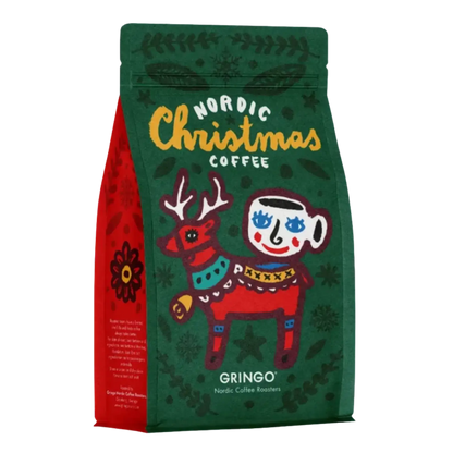 A stand-up coffee bag labeled 'Nordic Christmas Coffee' by Gringo, featuring a dark green front with a stylized red reindeer, yellow script text, and a red side panel on a white background.