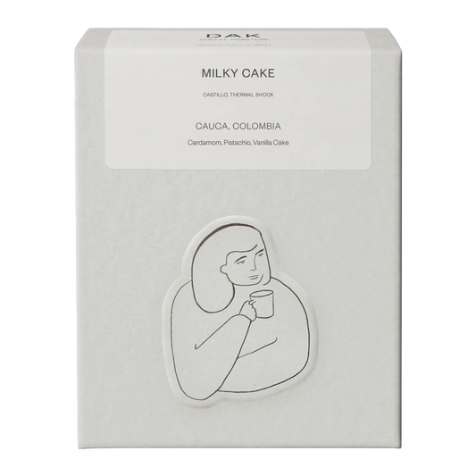 White box of DAK Coffee Roasters Milky Cake Filter Whole Beans with black on white drawing of a person