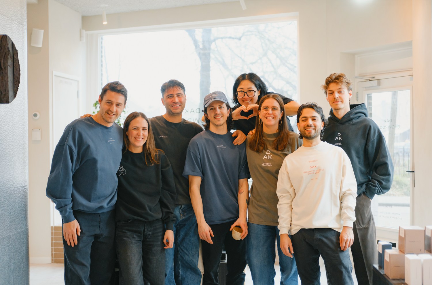 Group of people posing together in a modern indoor setting