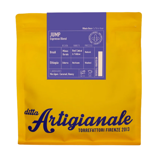 A yellow coffee bag with a purple label reading 'JUMP Espresso Blend' and large 'ditta Artigianale' branding on the front, photographed on a plain white background.