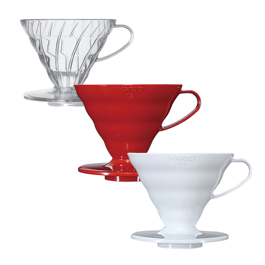 Three HARIO plastic pour-over coffee drippers size 2 in clear, red, and white, arranged diagonally on a solid white background.