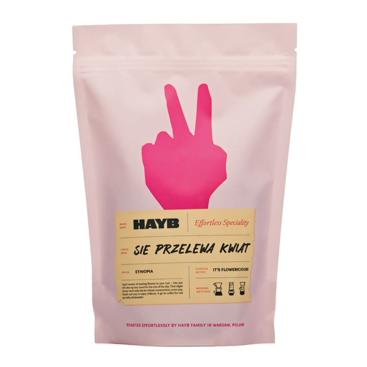 Rosa kaffepåse med ett fredssymbol och 'HAYB' branding på vit bakgrund