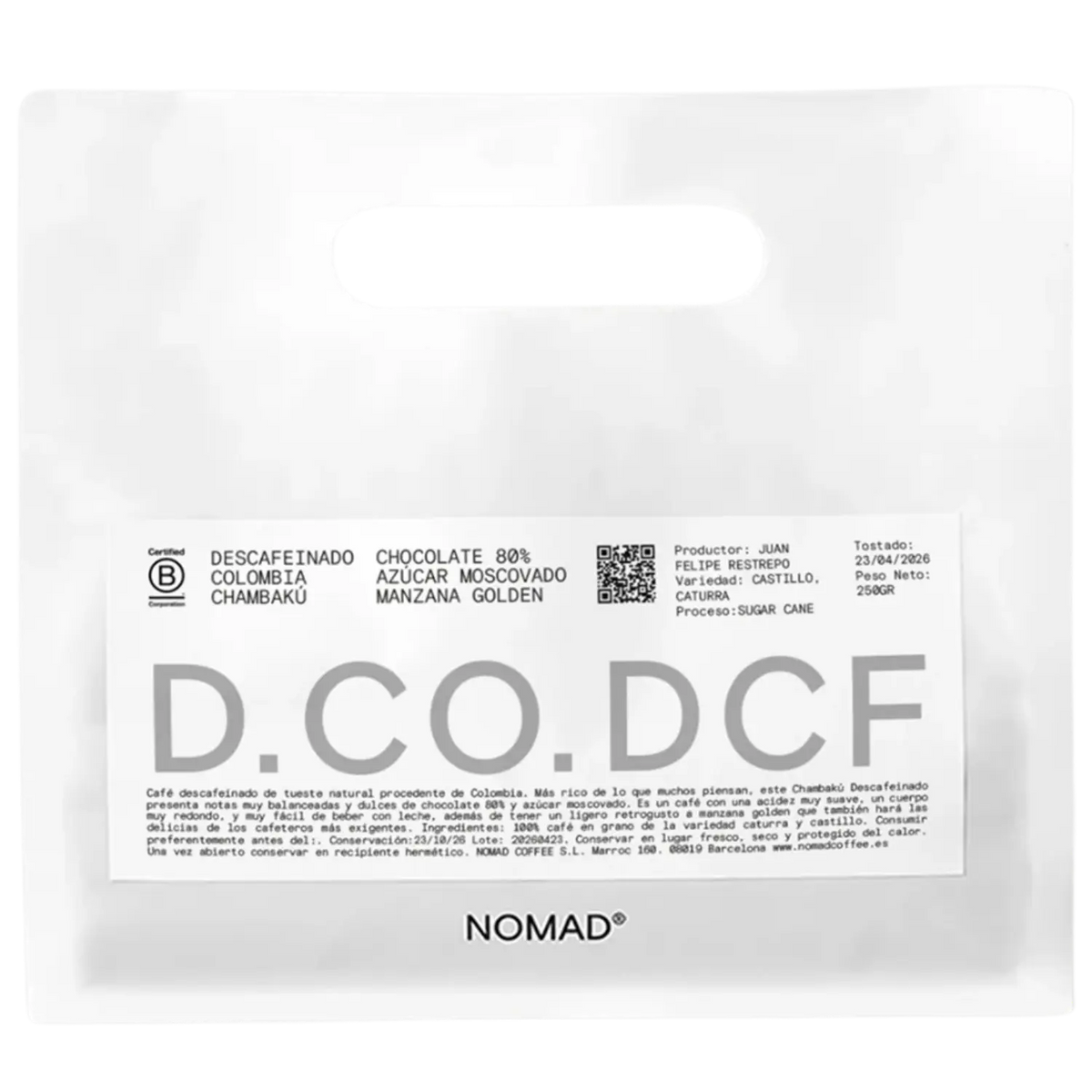 A white stand-up pouch of NOMAD Chocolate 80% Descafeinado Colombia Chambaku, featuring a white label with black and gray text and a QR code.