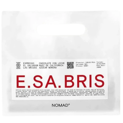 A white bag of NOMAD brand coffee with a prominent white label featuring the brand name 'E.SA.BRIS.