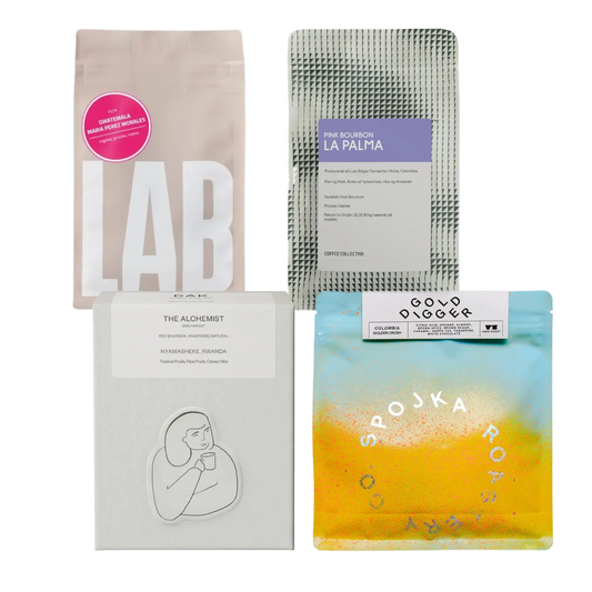 Four coffee bags from different brands on a white background
