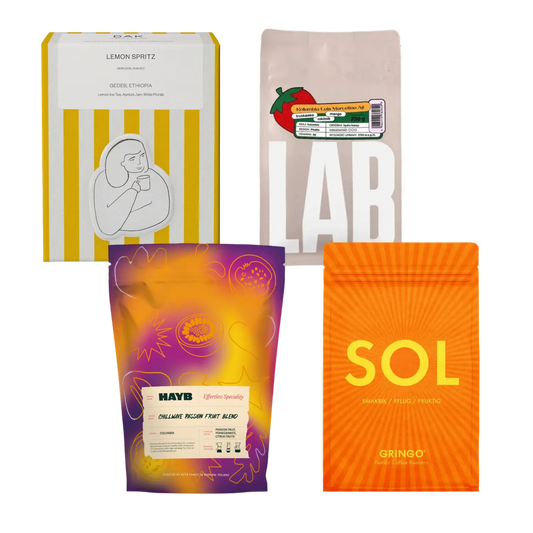 Four coffee bags from different brands on a white background