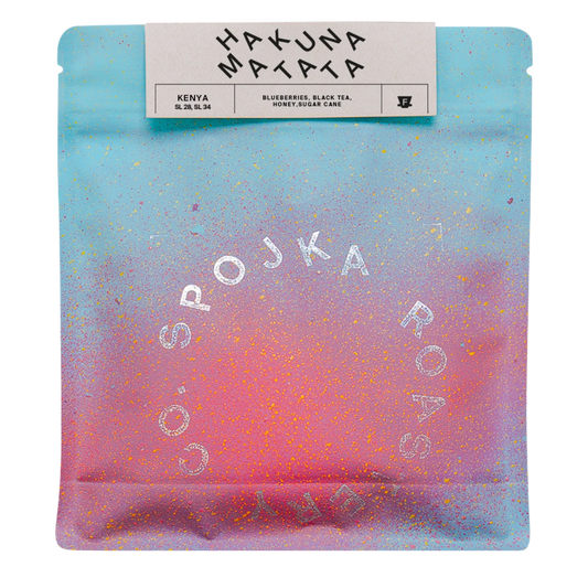 Packaged coffee with 'HAKUNA MATATA' and 'SPOJKA ROASTERY' branding on a gradient background