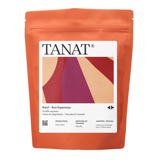 A stand-up pouch of TANAT Brazil - Boa Esperança espresso beans, featuring a bright orange-brown packaging with a large white label containing a geometric design.
